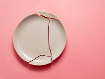 broken plate on pink background